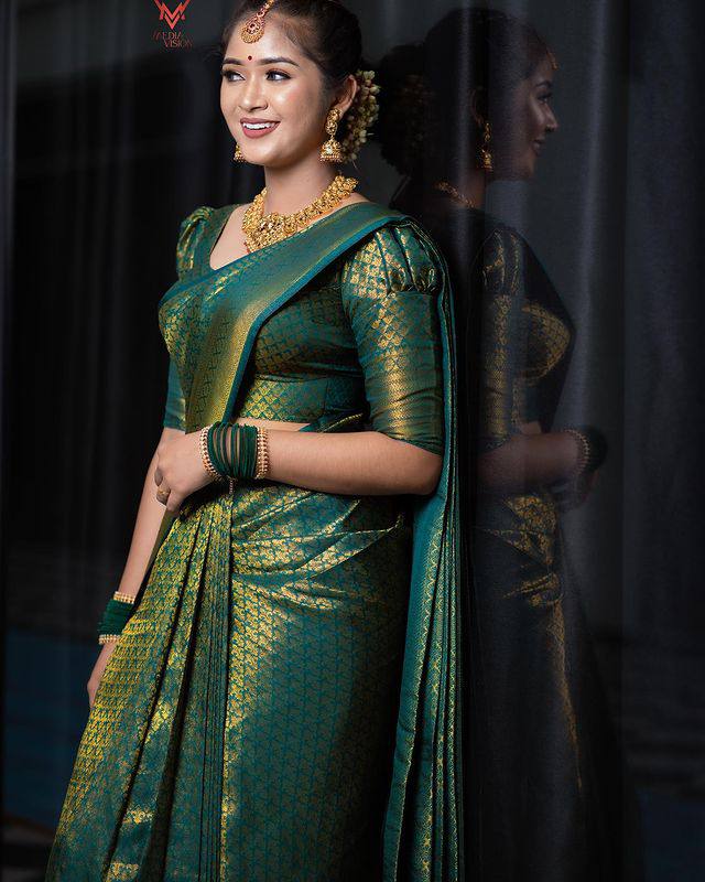 Stunning Dark Green Semi Silk Saree Weaved With Golden Zari With Attached Brocade Blouse