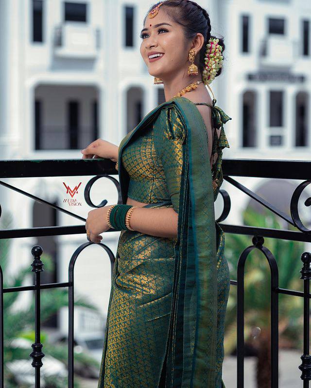 Stunning Dark Green Semi Silk Saree Weaved With Golden Zari With Attached Brocade Blouse